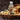 Bottle of Brooklane Almond Oil on a wooden surface with almonds and flowers.