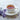 White cup of steaming tea with lavender flowers on a light surface
